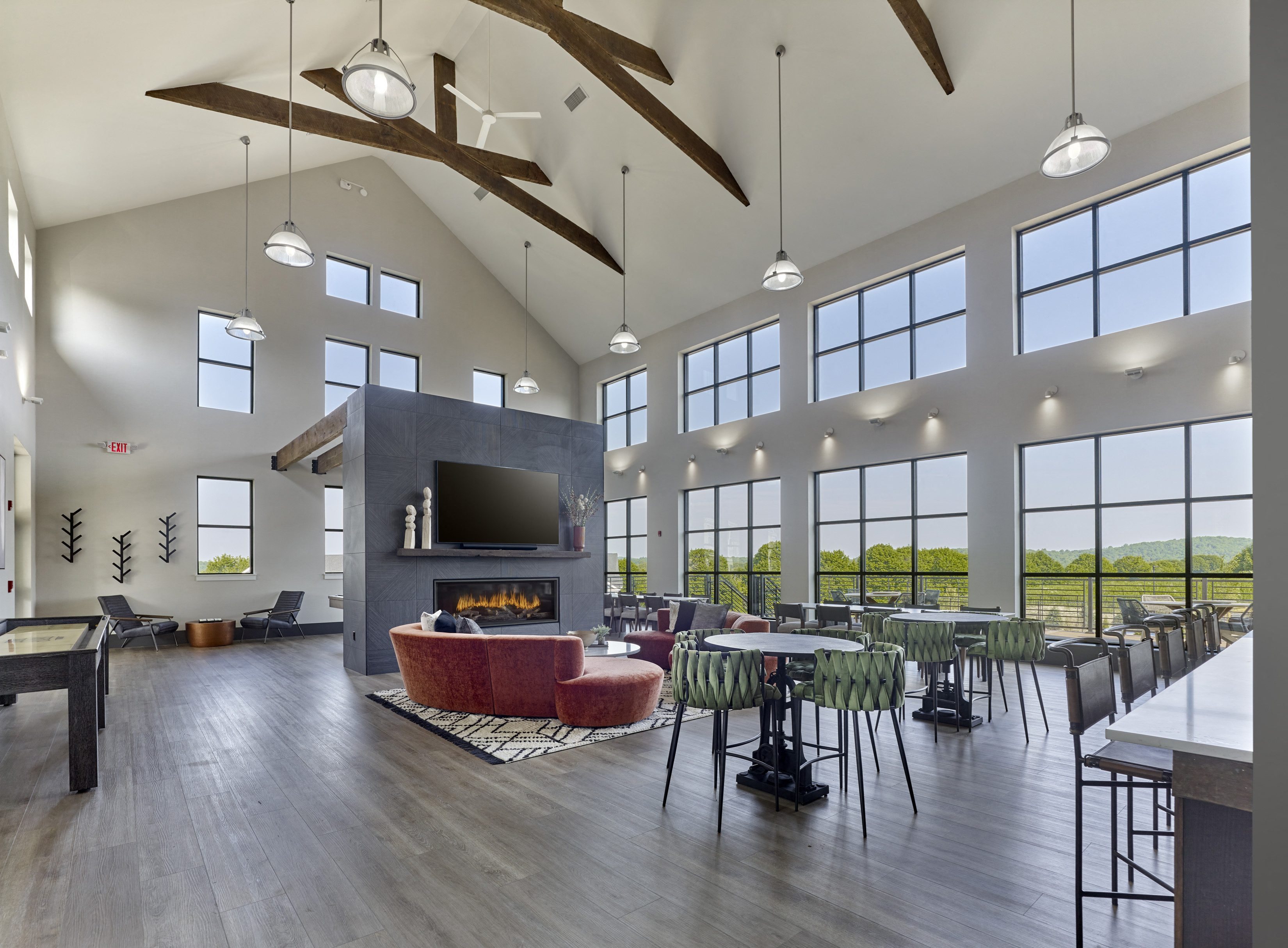 a large living room with a fireplace and tables and chairs